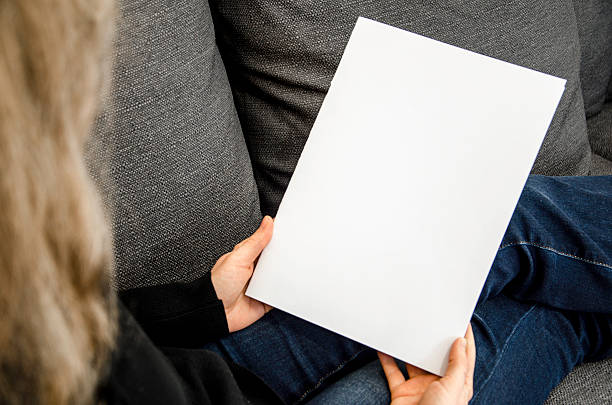 istock Looking at a blank paper magazine 506991960
