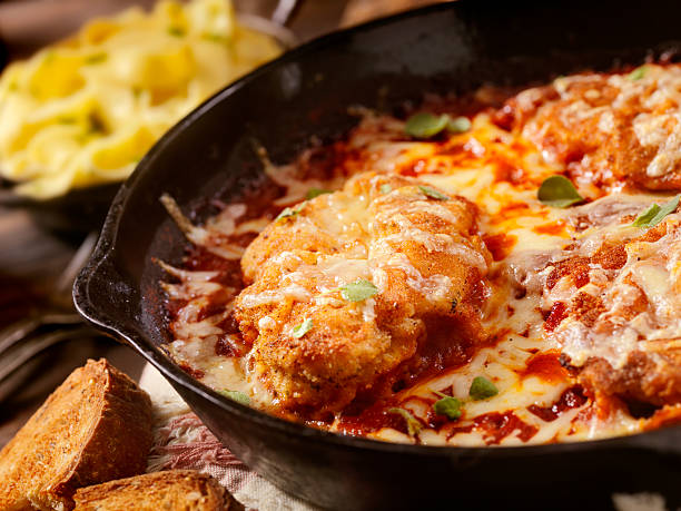 Chicken Parmesan Baked in Tomato Sauce with Mozzarella Cheese Chicken Parmesan Baked in Tomato Sauce with Mozzarella Cheese- Photographed on a Hasselblad H3D11-39 megapixel Camera System cooked selective focus indoors studio shot stock pictures, royalty-free photos & images