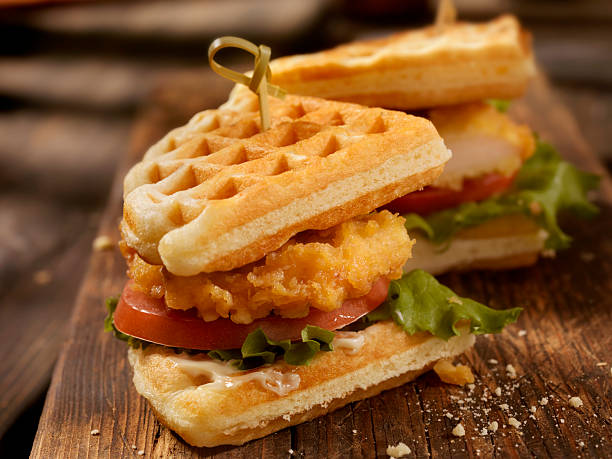 Fried Chicken and Waffle Sandwich Fried Chicken and Waffle Sandwich with Lettuce and Tomato-Photographed on Hasselblad H3D2-39mb Camera dark inner thighs stock pictures, royalty-free photos & images