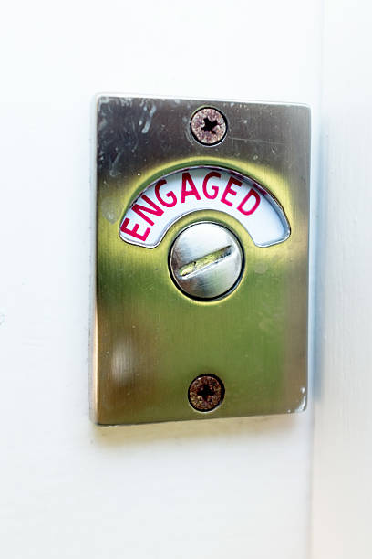 istock Engaged sign on public bathroom door 506995488