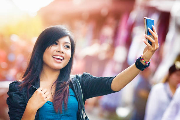 istock Cheerful Young Indonesian female shooting a selfie 506996654