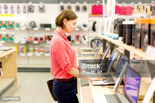 istock woman chooses the laptop 506998184