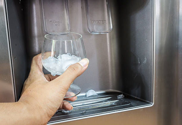 istock Hand with ice dispenser and glass 507001460