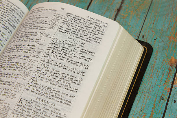 istock Bible Opened to Psalm on wooden plank background 507001864