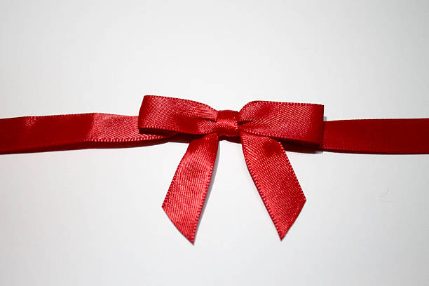 istock Red Ribbon Gift Bow Close Up 507003452