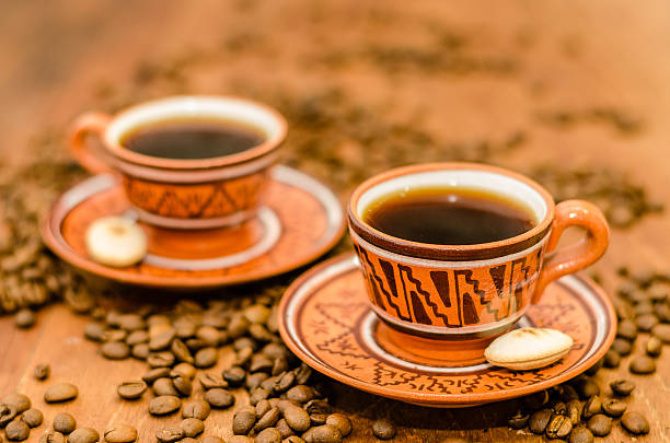 Coffee with steam, grains on a wooden table stock photo