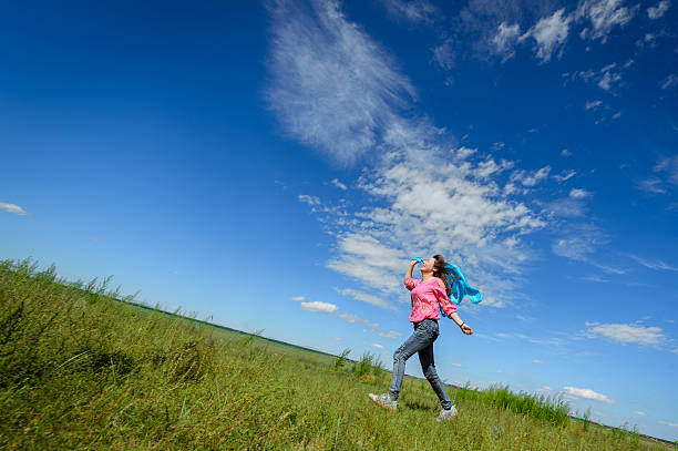 Asian young girl Running over a grass field