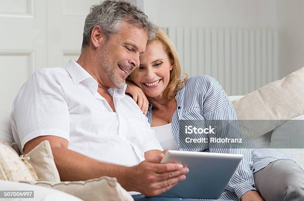 Happy Mature Couple With Tablet Stock Photo - Download Image Now - Couple - Relationship, Mature Couple, Digital Tablet
