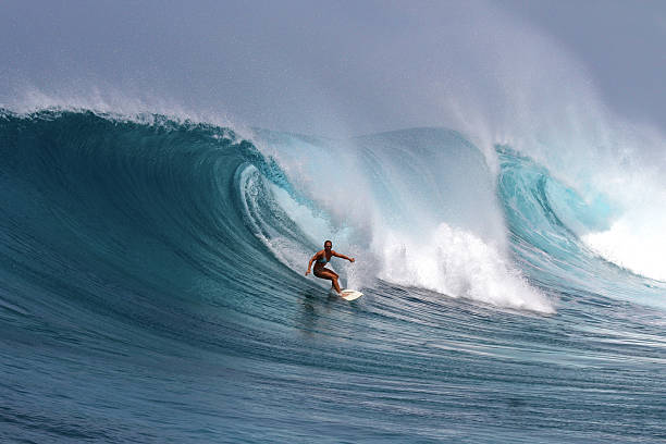 istock Brave girl surfs a big powerful wave 507005400