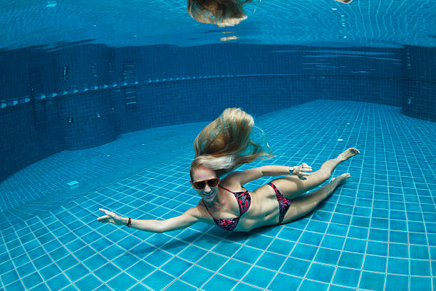 istock Girl poses undewater in a pool 507006302