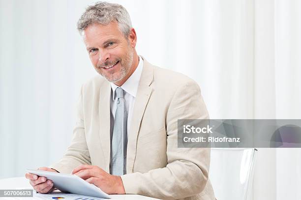 Happy Mature Businessman With Tablet Stock Photo - Download Image Now - 40-49 Years, 50-59 Years, Active Seniors