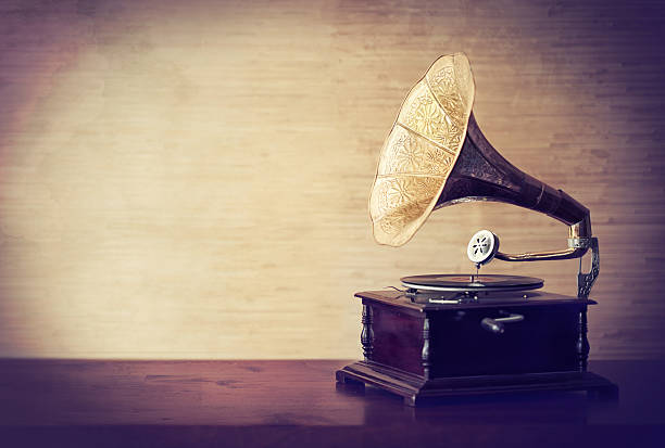 Getting lost in the music of old Shot of a vintage gramophone placed on a table gramophone stock pictures, royalty-free photos & images