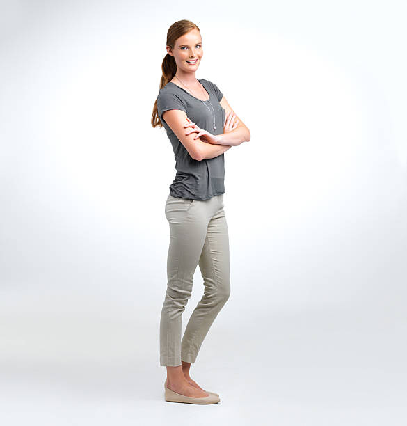 Young and confident Portrait of an attractive young woman standing in a studio with her arms crossed women young women standing full length stock pictures, royalty-free photos & images