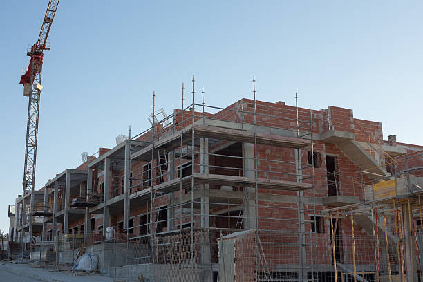 istock Brick houses with a crane 507009183