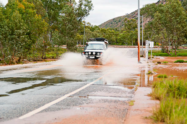 un floodway 4 roues motrices crossing - emu australia northern territory outback photos et images de collection