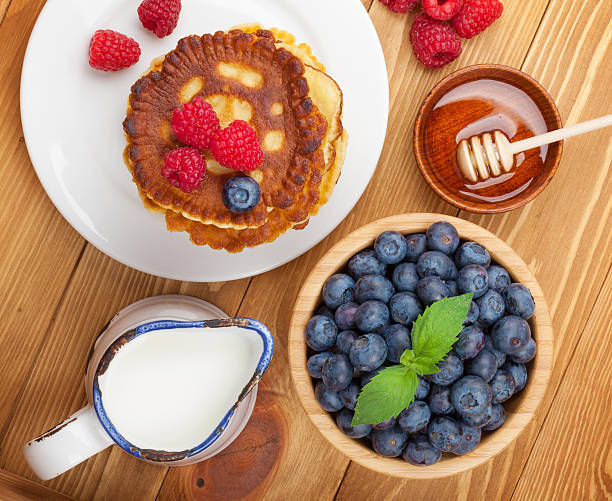 Pancakes with raspberry, blueberry, mint and honey syrup
