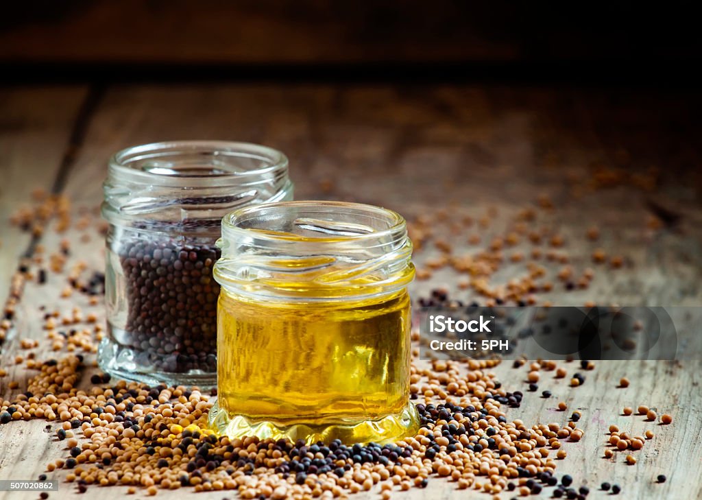 Oil from the seeds of the black mustard Oil from the seeds of the black mustard, selective focus Cooking Oil Stock Photo