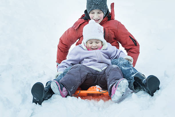 istock Children having fun during outdoor winter activity with snow slider 507022044