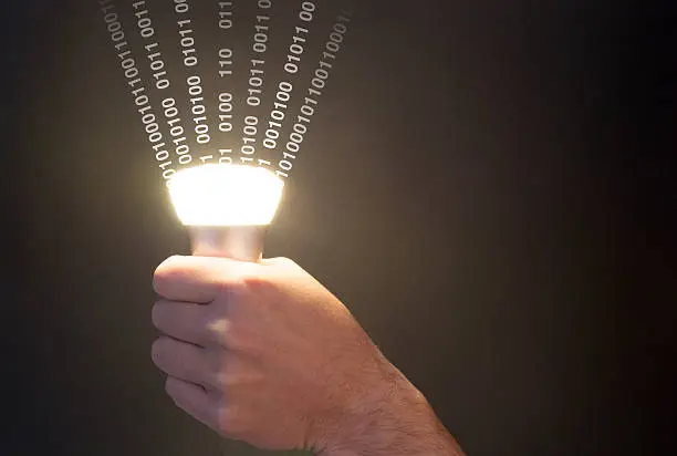 Photo of Lifi concept with bulb emitting data and hand