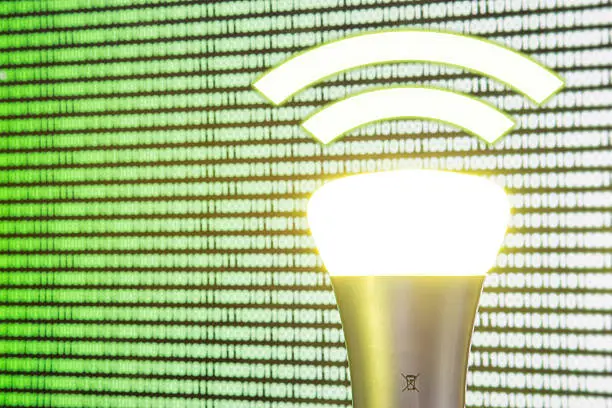 Photo of Lifi symbol with bulb in front of screen
