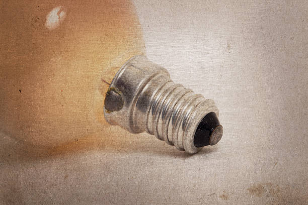 istock Old orange lightbulb isolated on a white background 507026748