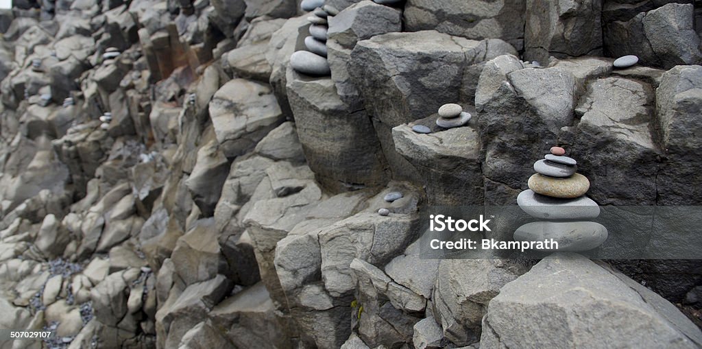 Stacked Stones Stacked Stones near Dryholaey on Reynisfjara Beach in Southern Iceland. Atlantic Ocean Stock Photo