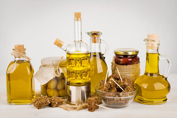 istock Composition of olive oil bottles and black bread on table 507029332