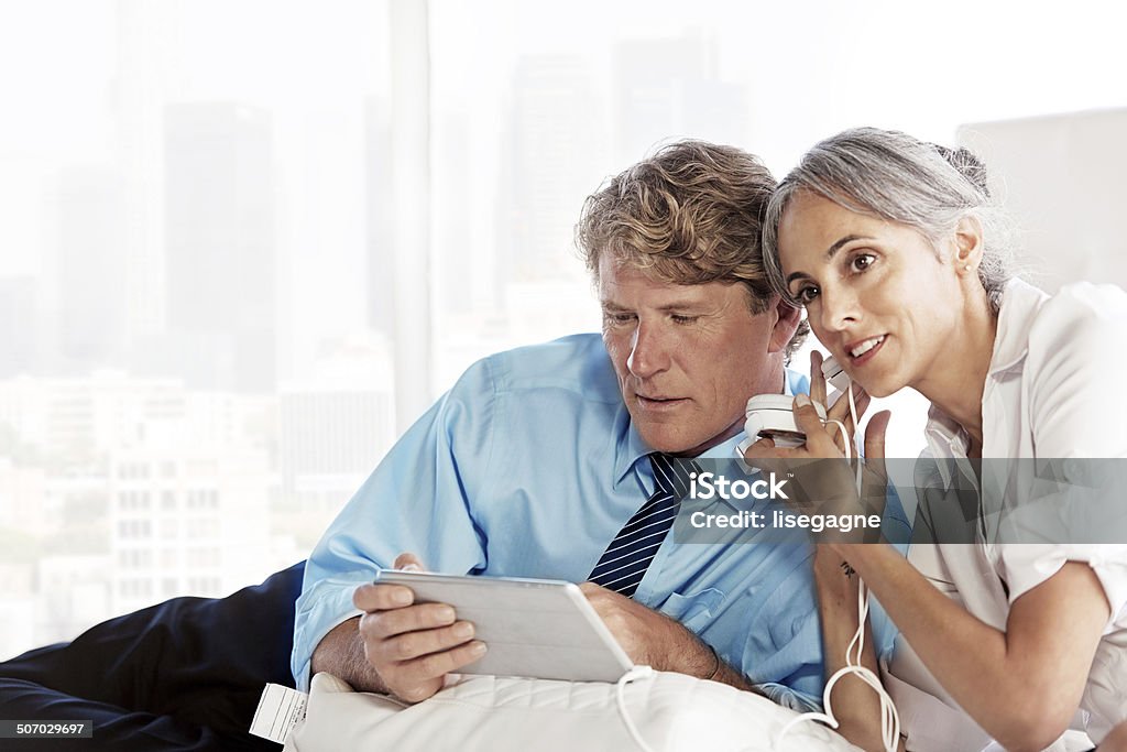 Business couple using a digital tablet Business couple using a digital tablet.  Istockalypse LA, California 50-59 Years Stock Photo