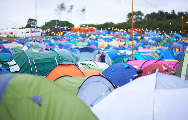 Tent city! Shot of a campsite filled with many colorful tents at an outdoor festival music festival camping summer vacations stock pictures, royalty-free photos & images
