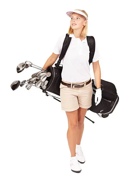 Shot of a beautiful young golfer carrying her bag isolated on white
