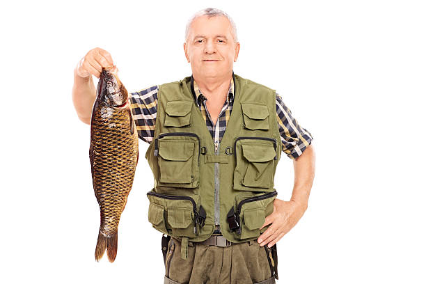 istock Smiling mature fisherman holding a big fish 507030909