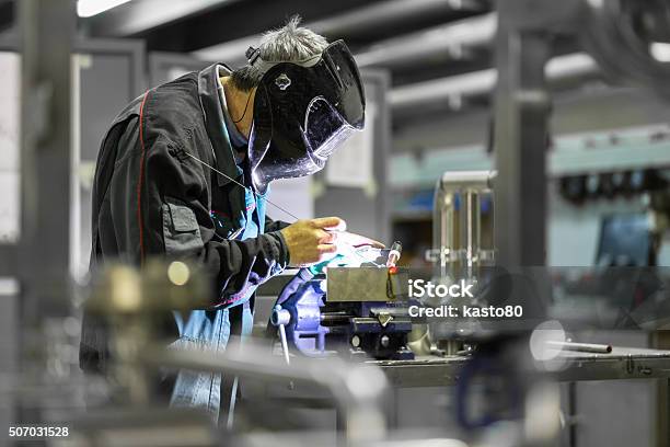 Industrial Worker Welding In Metal Factory Stock Photo - Download Image Now - Factory, Manufacturing, Occupation