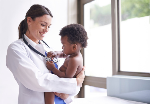 Shot of an attractive female pediatrician doing a checkup on an adorable baby boy