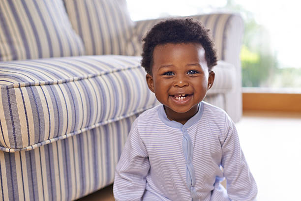 Getting his cute on Shot of an adorable little baby boy at home baby boy stock pictures, royalty-free photos & images