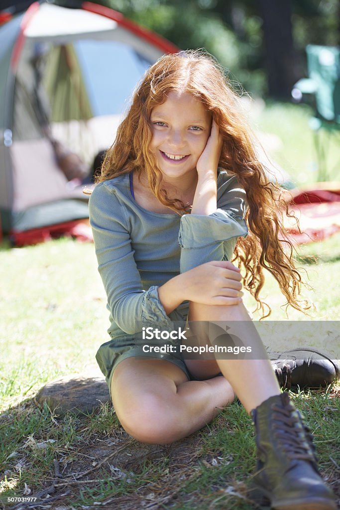 She has a mind behind that cute face Portrait of a young girl sitting outdoors with a tent in the background 14-15 Years Stock Photo