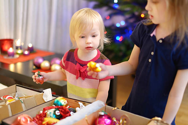 istock Two little sisters decorating a Christmas tree 507032592