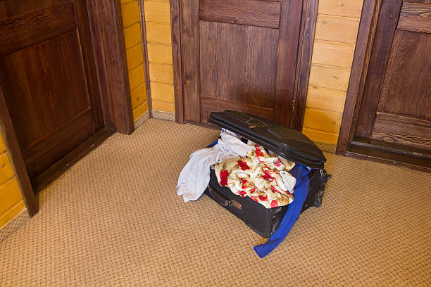istock Suitcase full of things at the door 507033436