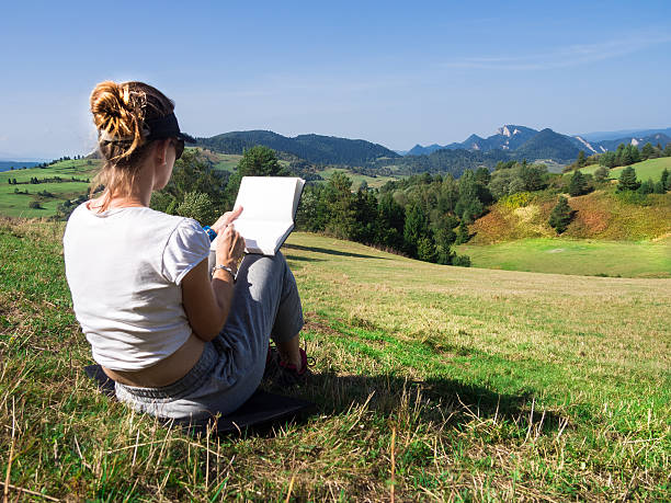 istock Woman artist working outdoors on hillside 507034542