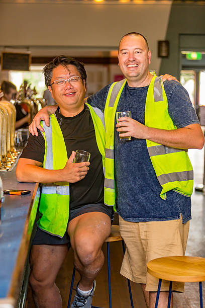 istock Workmen Relaxing With Beer After Work in High Visibility Clothes 507036316