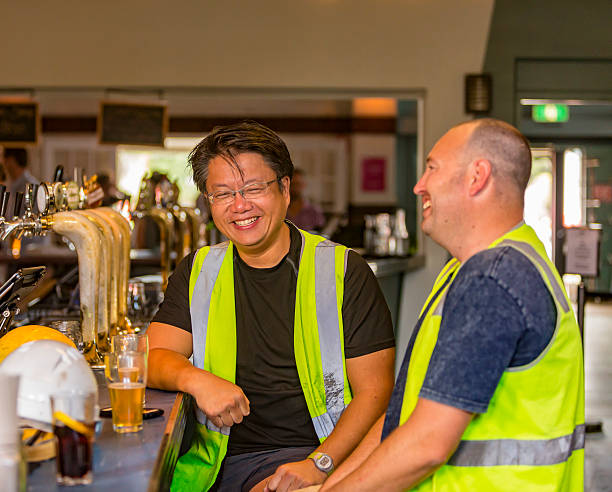 istock Workmen Relaxing With Beer After Work in High Visibility Clothes 507036490