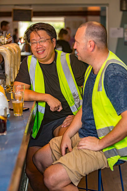 istock Workmen Relaxing With Beer After Work in High Visibility Clothes 507036678