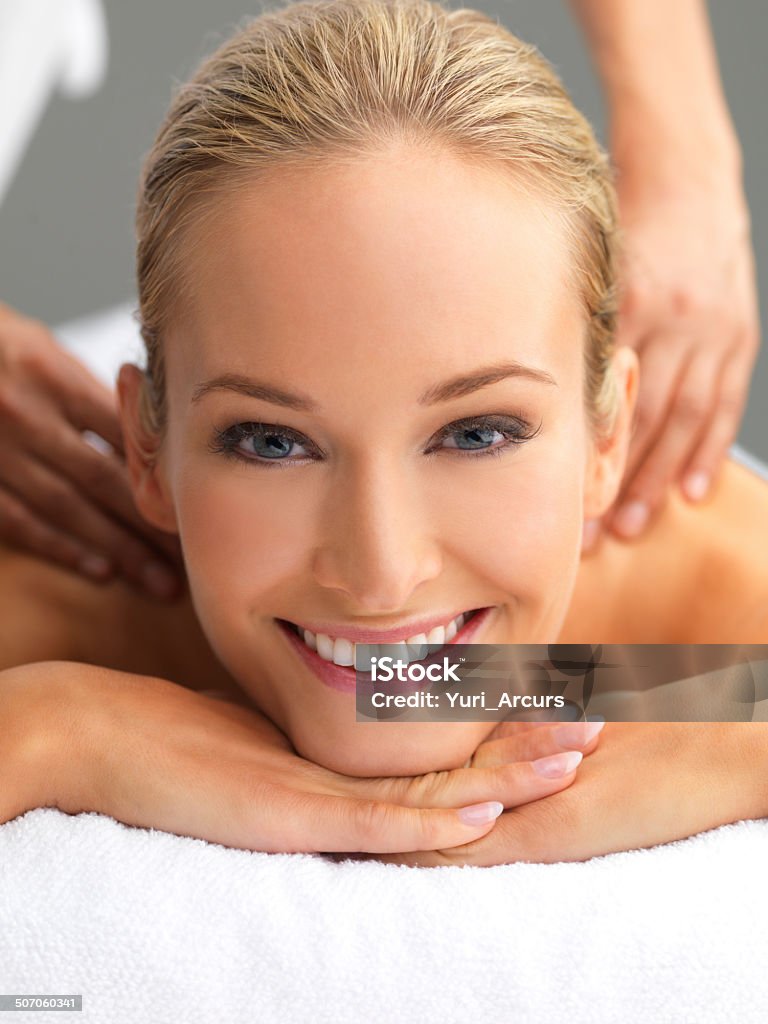 Enjoying the rejuvenating powers of massage A beautiful young woman relaxing in a spa - portrait 20-29 Years Stock Photo