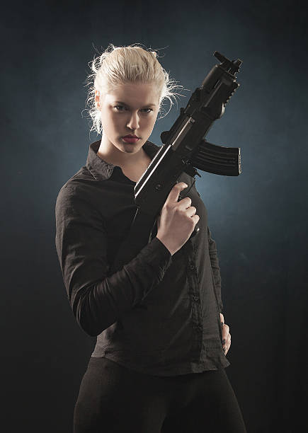 istock Young woman with gun 507060817