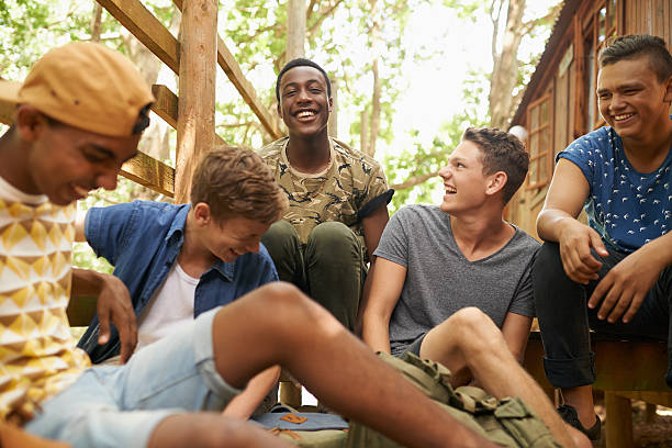 You guys crack me up! Shot of a group of teen boys hanging out together outside teenage boys stock pictures, royalty-free photos & images