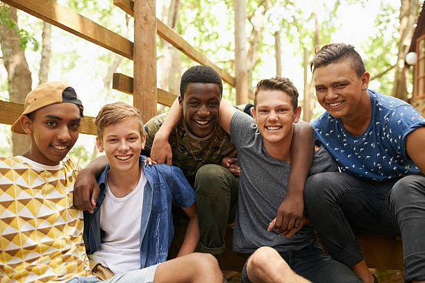 The boys are back together Shot of a group of teen boys hanging out together outside teenage boys stock pictures, royalty-free photos & images