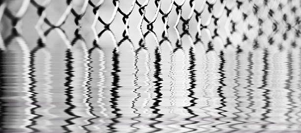 istock Iron steel mesh reflection in the water surface 507063861