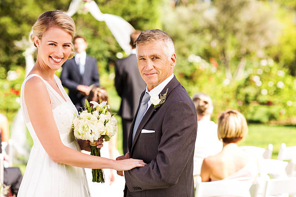 istock Bride Holding Flower Bouquet While Standing With Father 507064295