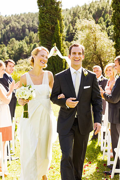 istock Couple Walking Together With Guests Clapping During Ceremony 507064451