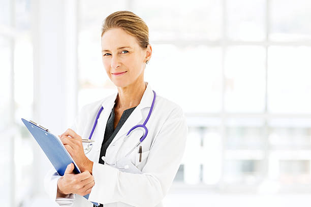 istock Confident Doctor Writing On Clipboard In Hospital 507064903