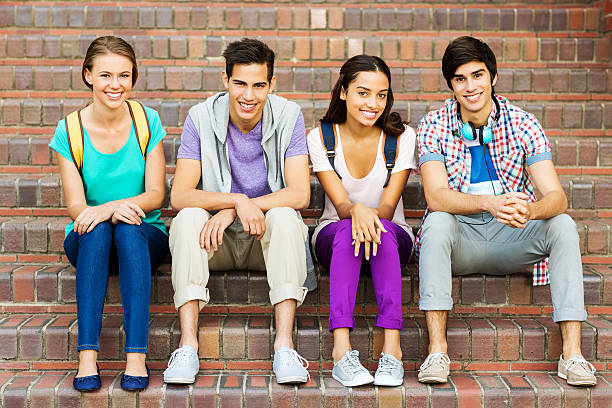 istock Happy Group of Students Sitting On Steps At College Campus 507065273